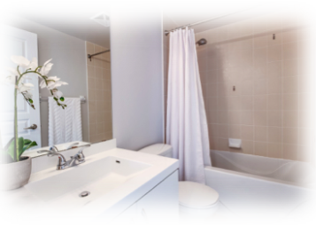 Image Of A Bathroom With A White Sink, Toilet And Bathtub And Tan Tile With A White Orchid Flower In A White Pot On The Counter With A Link To One Stop Plumbing’s Faucets, Toilets & Sinks Page