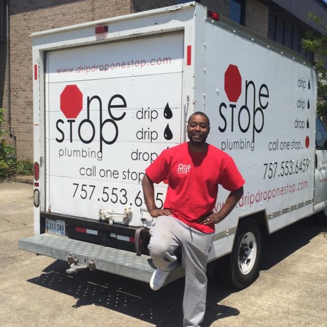 One Stop Plumbing’s owner Nevie Sessoms in a red shirt standing in front of the One Stop Plumbing truck about Us