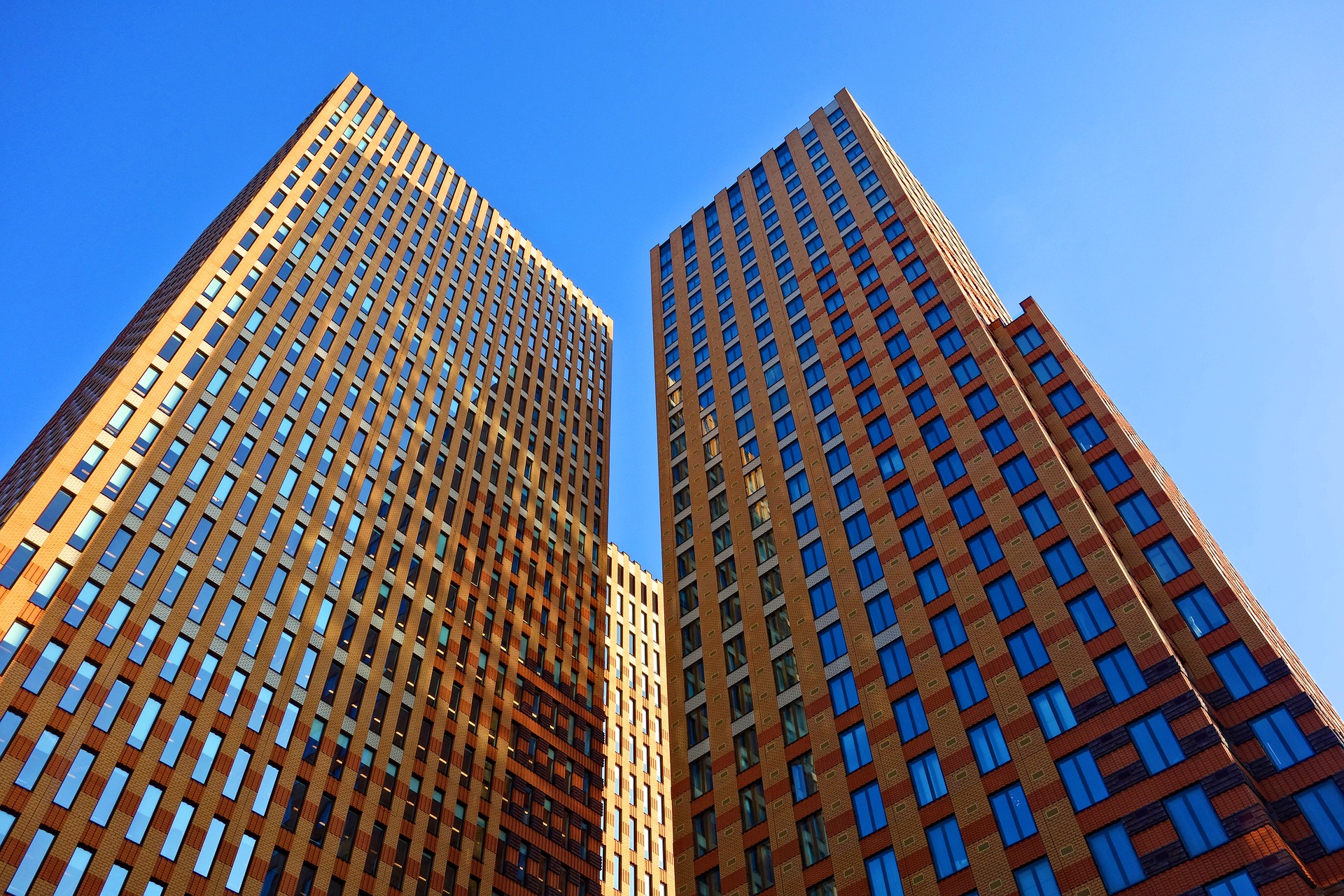 Two office tower buildings in brick and glass for plumbing and gas services for business or building owners on the One Stop Plumbing commercial Plumbing page