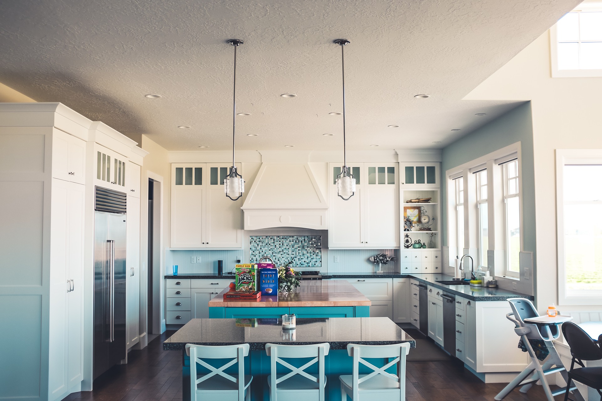 Remodeled kitchen in white and aqua blue with new appliances on the One Stop Plumbing page for Plumbing Remodeling