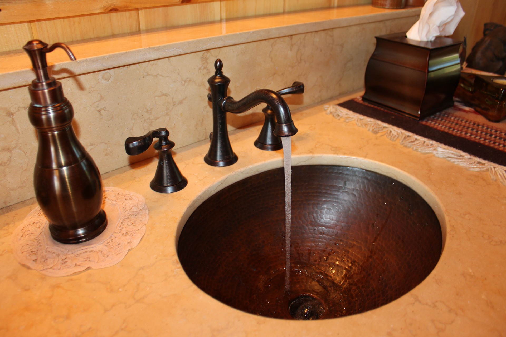 Bathroom sink with running faucet marble counter top brass fixtures and sink on the One Stop Plumbing Do It Yourself DIY page