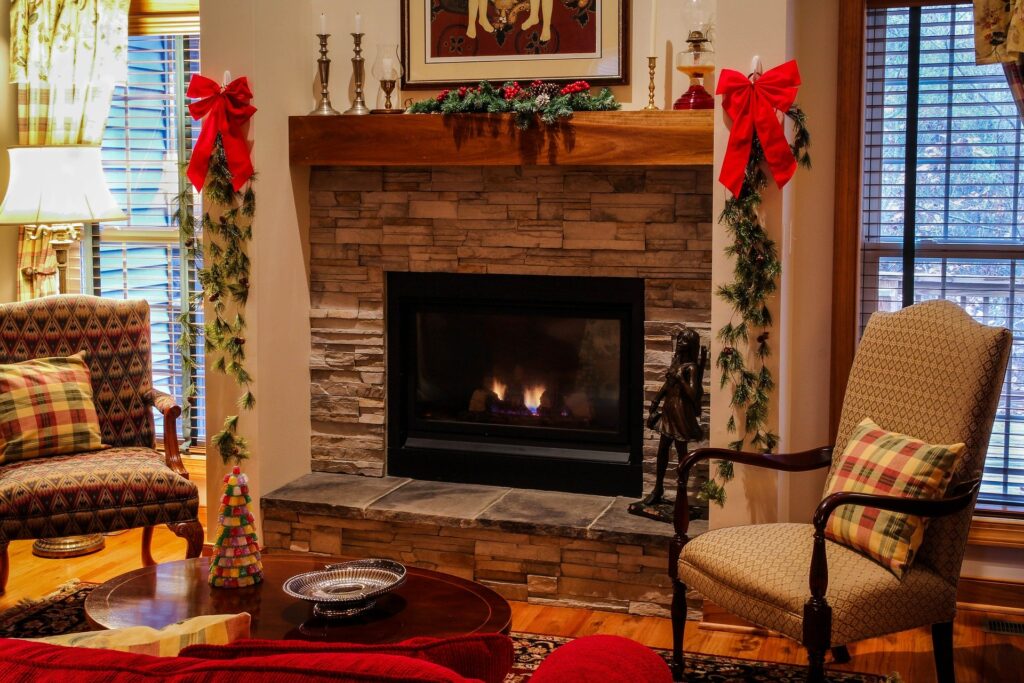 A brick gas fireplace in a living room decorated for Christmas on the One Stop Plumbing gas appliances page