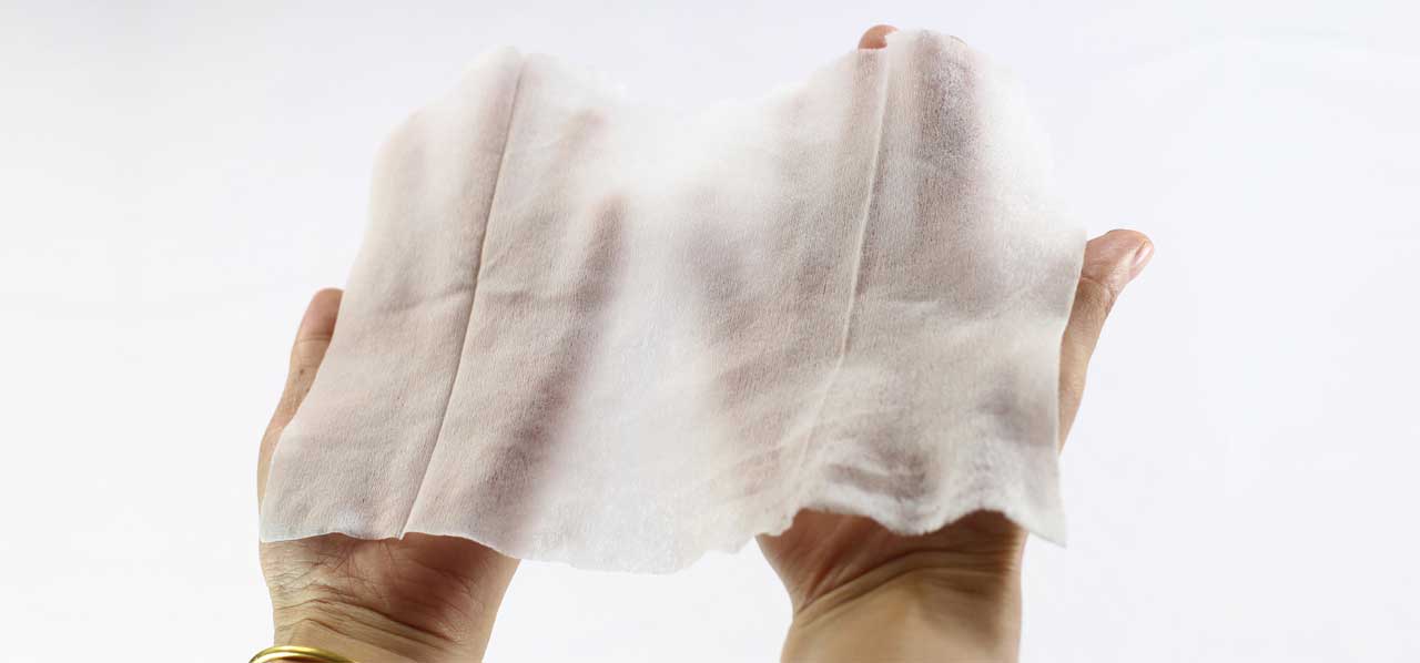 Hands holding a wipe that should not be flushed
